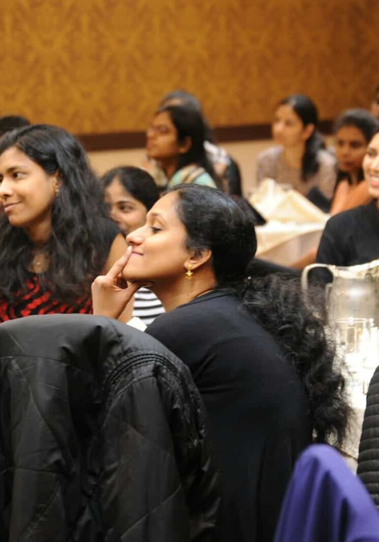 group of women sitting on chair while listening