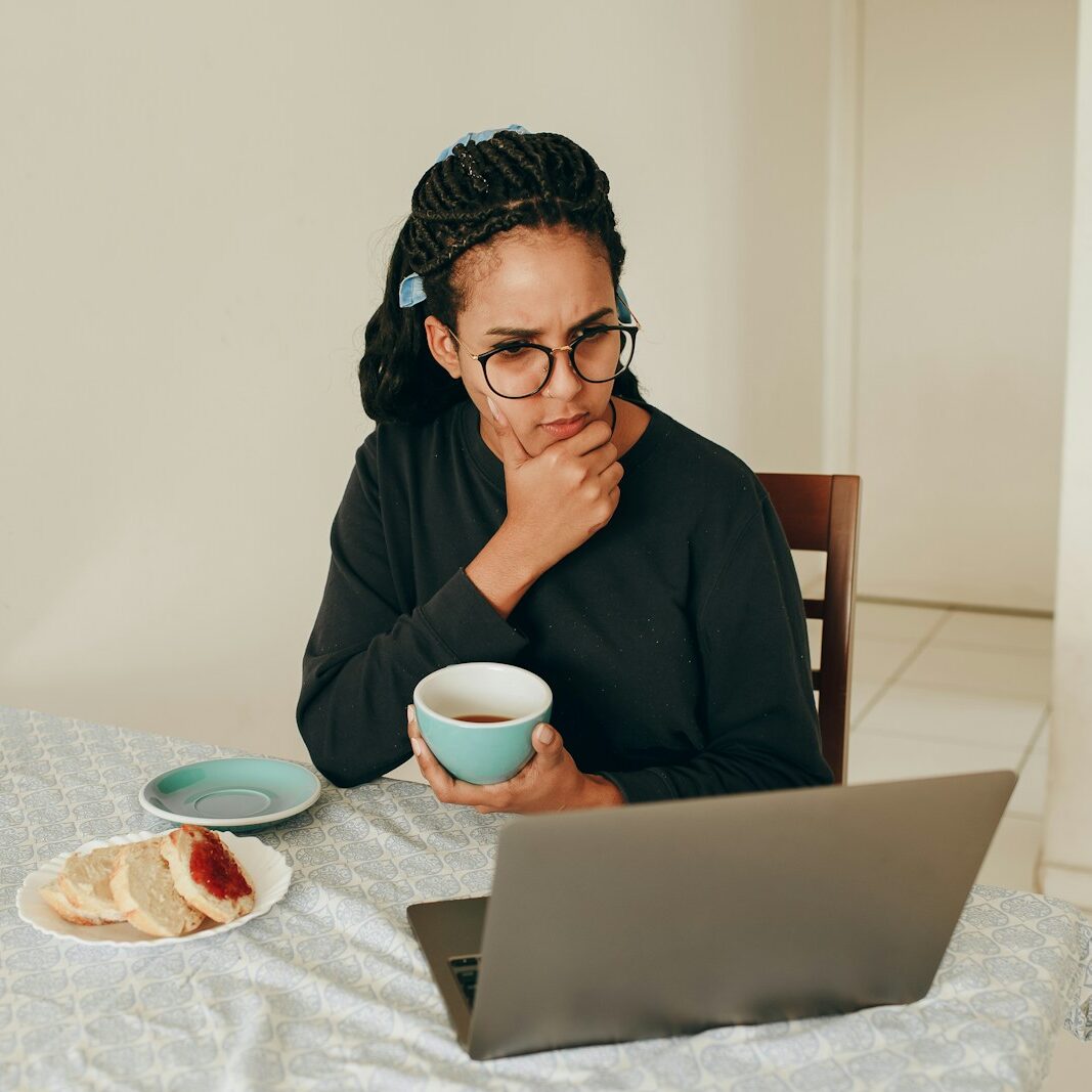 woman in black long sleeve shirt wearing black framed eyeglasses